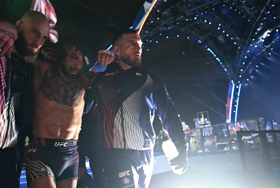 Aleksandre Topuria assists his brother Ilia Topuria after his loss in a lightweight title bout.