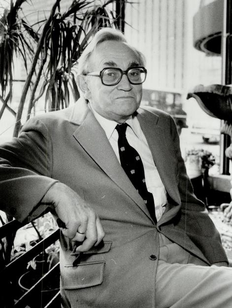 Psychiatrist and gerontologist Dr. Alex Comfort in a professional portrait.