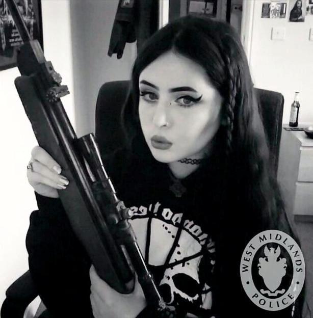 Alice Cutter, a Neo-Nazi extremist, posing for a photo while holding a gun.