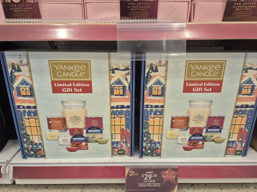 Two Yankee Candle Christmas Collection 8 Piece Gift Sets on a store shelf, priced at £29.50 each, with original price £60.