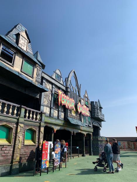 The exterior of "Terror Castle" at Brean Theme Park, with a family in the foreground.