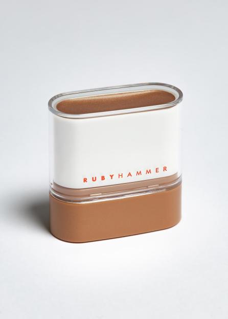 A Rubyhammer product in a clear and white container with a brown base, filled with brown product.