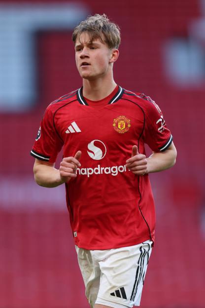 A Manchester United player in a red jersey and white shorts running during an FA Youth Cup match against Crystal Palace.