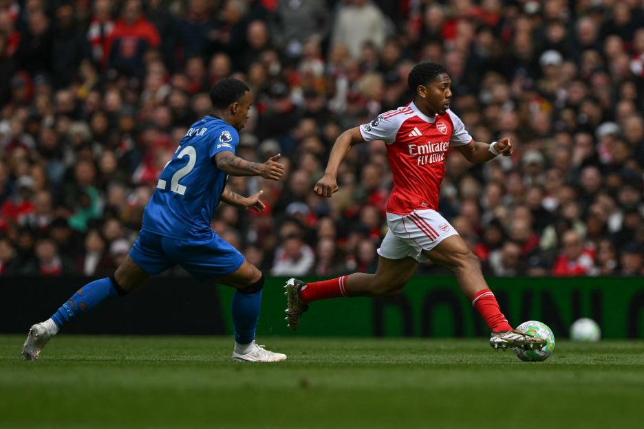 Bournemouth's Eli Junior Kroupi chasing Arsenal's Myles Lewis-Skelly during a football match.