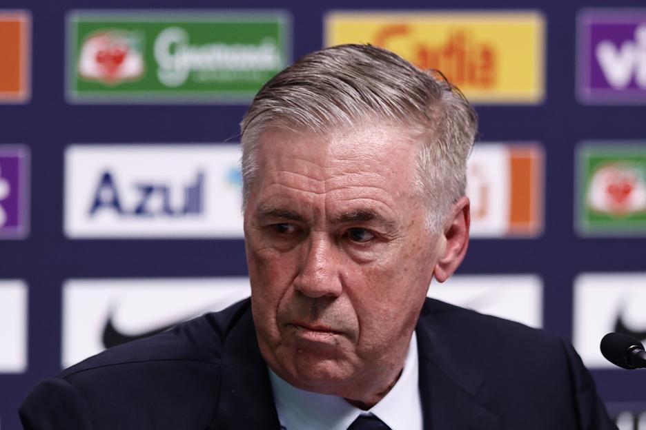 Carlo Ancelotti speaking into a microphone.