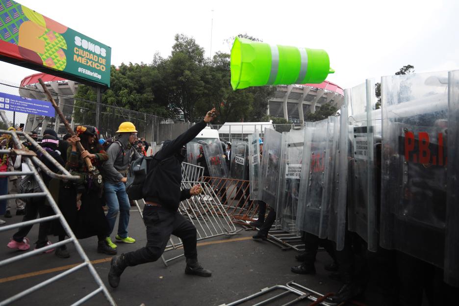 Demonstrators clash with police during the World Cup opener in Mexico City