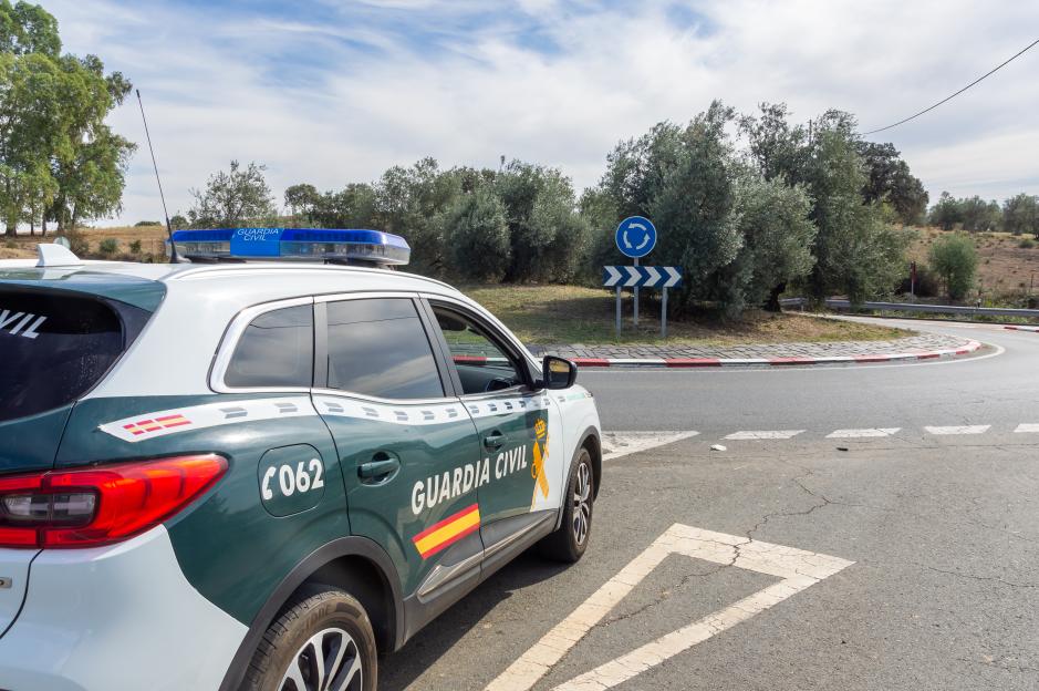 Patrol car of the Spanish Civil Guard, on the road next to a roundabout.