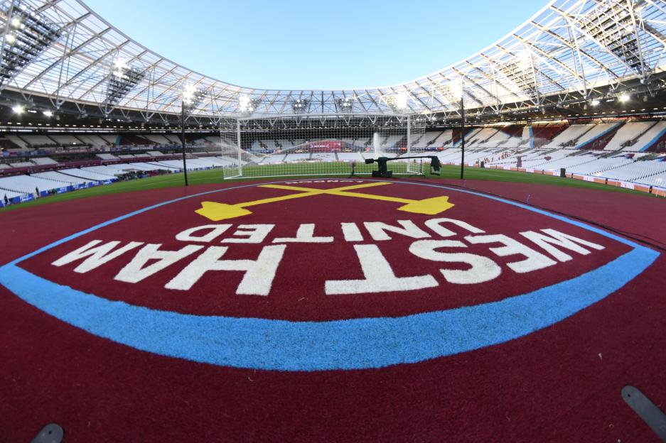 View inside London Stadium, home of West Ham United, with the team's logo painted on the field.