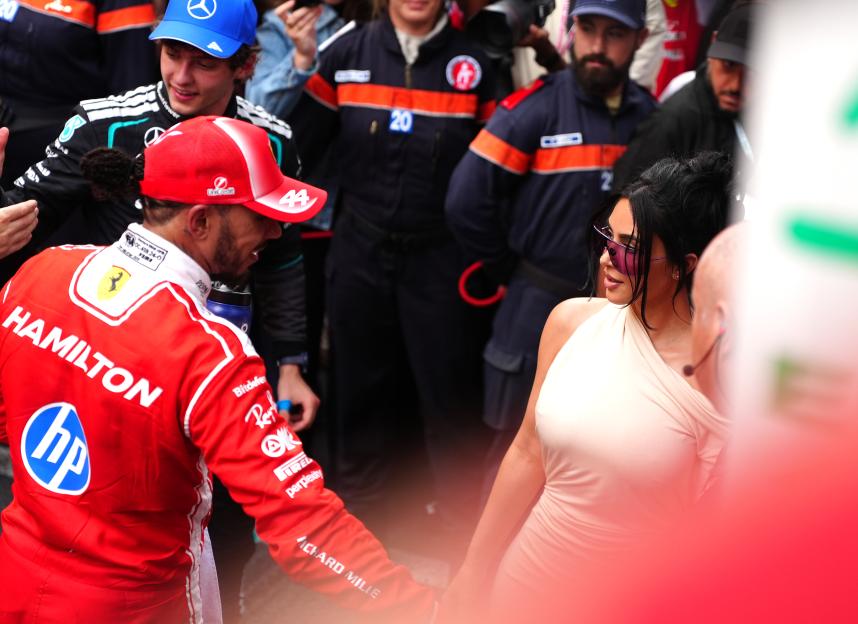 Lewis Hamilton in a red racing suit and Kim Kardashian in a beige dress after the Monaco Grand Prix.