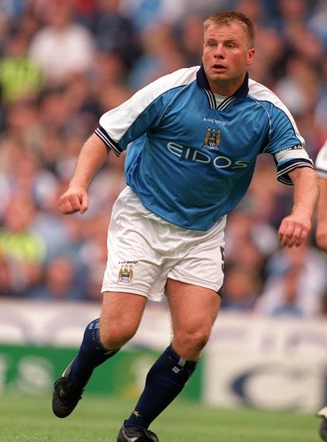 Andy Morrison of Manchester City wearing a sky blue and white uniform on a football pitch.