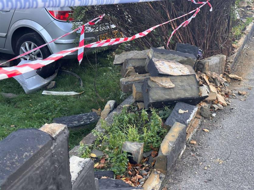 The aftermath of a drunk driver crashing a silver car into a bungalow, with debris and caution tape visible.
