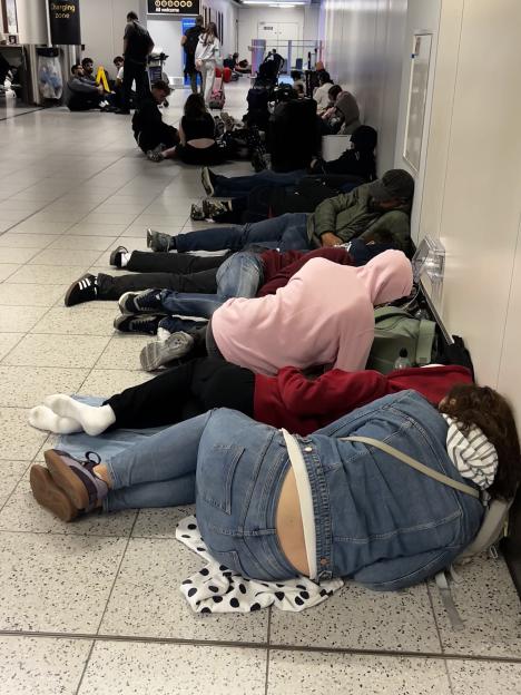 Travellers sleeping on the floor at Gatwick Airport due to an air traffic control technical failure.