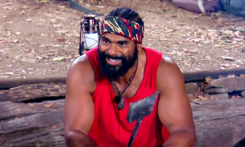 David Haye wearing a red tank top and camouflage bandana on "I'm A Celebrity... Get Me Out Of Here! South Africa".