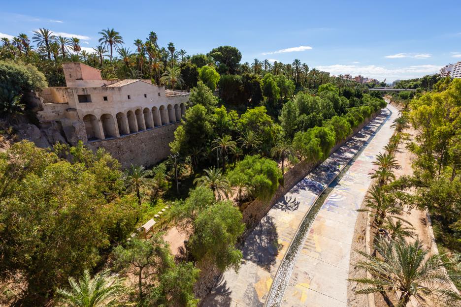 Moli del Real, an ancient mill, on the left side of the Valley of the Río Vinalopó, lined with palm trees at the Parque Municipal in Elche, Alicante Province, Spain.