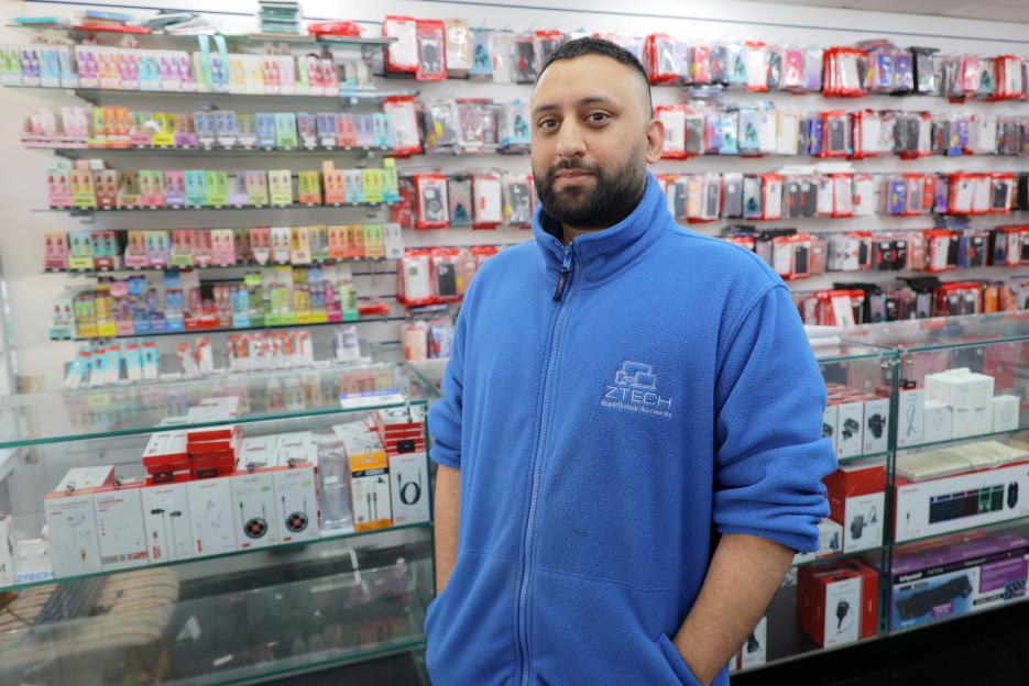 Vape and tech shop owner Zed Ali standing in his shop.