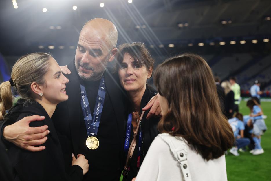 Manchester City manager Pep Guardiola celebrates winning the UEFA Champions League with his wife and two daughters.