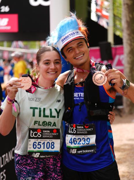 Tilly Ramsay Snuggles Up to Strictly's Nikita as They Show Off Their Medals After Conquering the London Marathon!