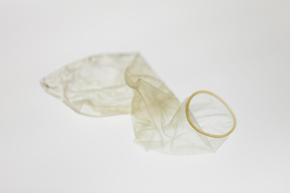 Used condom on a white background.