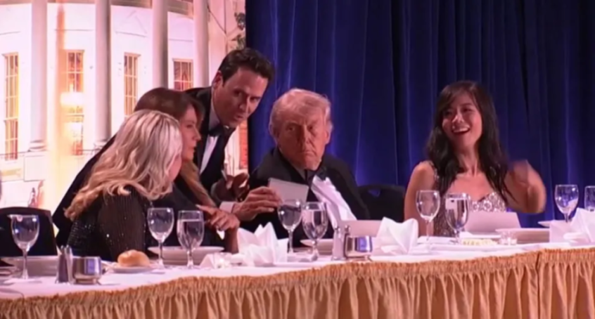Donald Trump with other people at a formal dinner event.