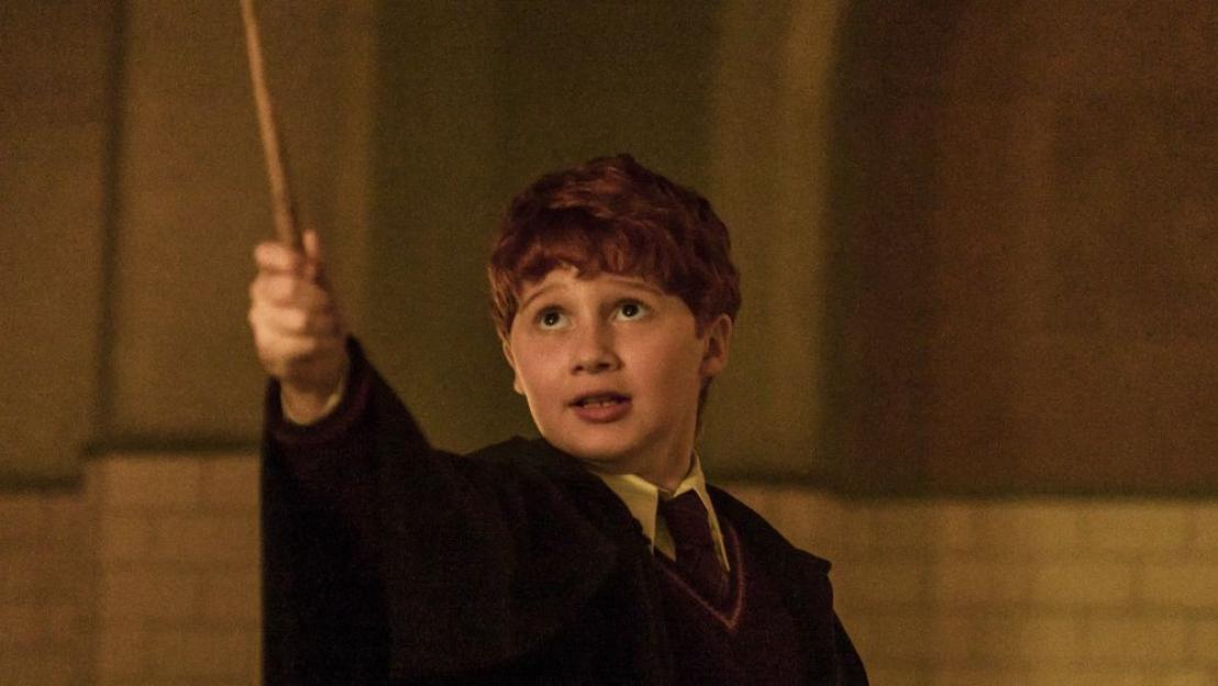 Alastair Stout as Ron Weasley holding a wand in the HBO show Harry Potter and the Philosopher's Stone.
