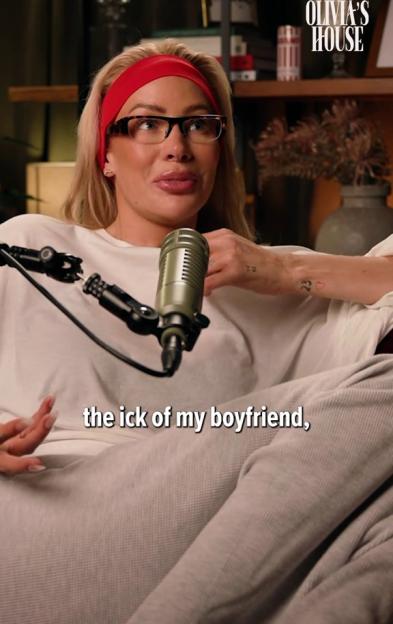Olivia Attwood wearing a red headband and glasses talking into a microphone, with the words "the ick of my boyfriend," on the screen.