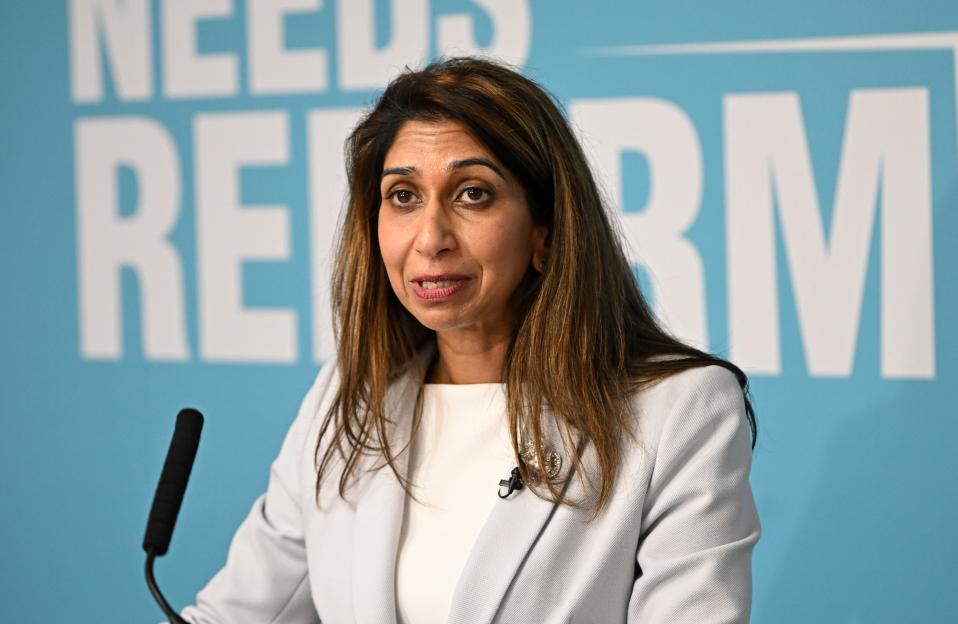 Reform UK leader Nigel Farage embracing former Conservative Home Secretary Suella Braverman at a press conference.