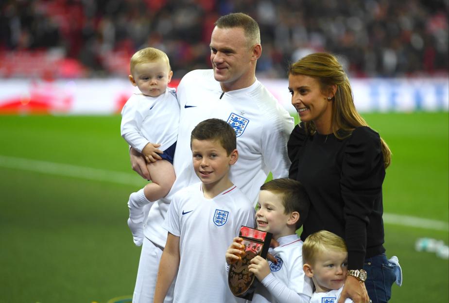 Wayne Rooney, his wife Coleen, and their four children pose for a photo.