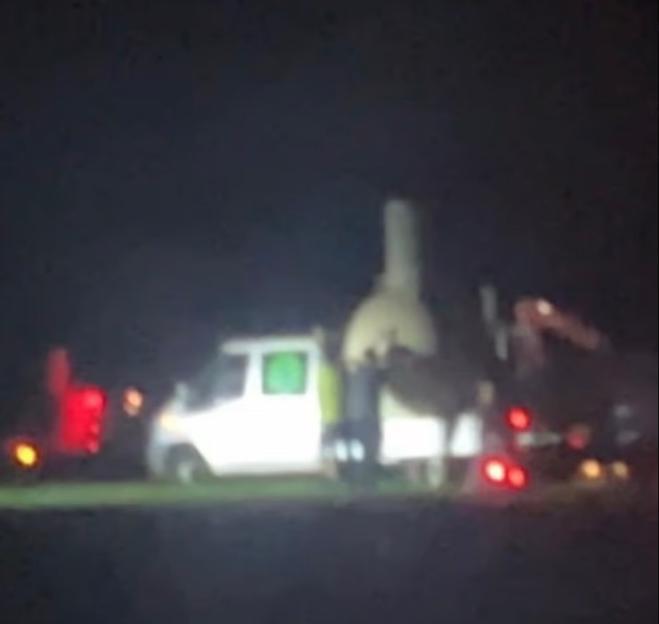 Trucks transporting a missile at night.