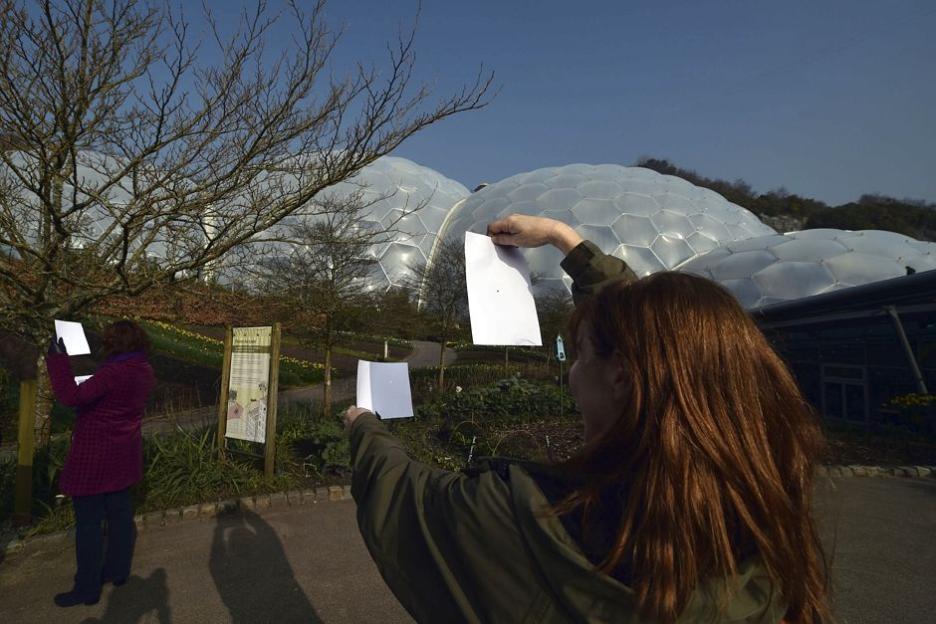 People watch the eclipse through "pinhole camera" at the Eden Project, Cornwall 