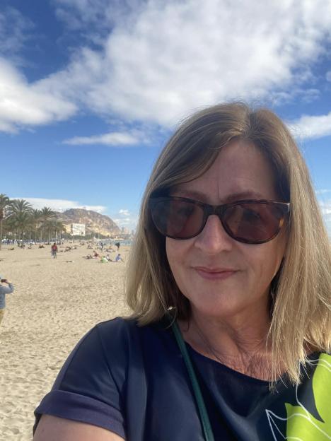 Helen Dalling at a sky bar, overlooking Palma with a cathedral in the background.