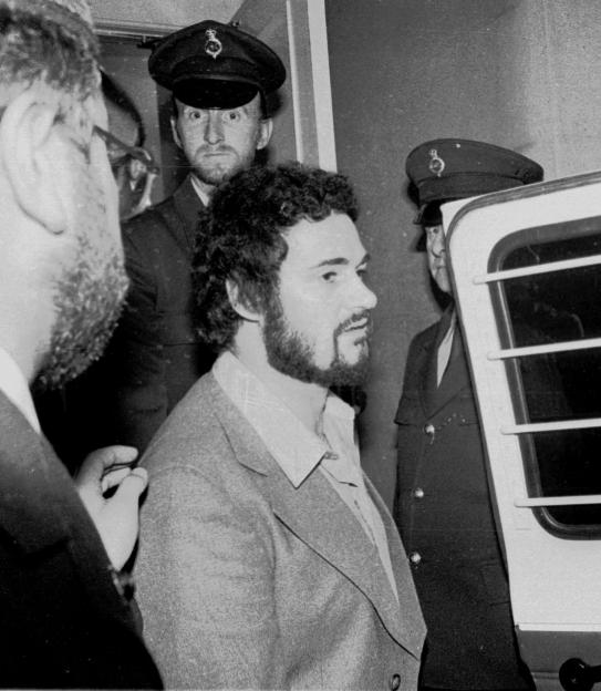 Peter Sutcliffe, the Yorkshire Ripper, exiting the Isle of Wight Crown Court, flanked by police officers.