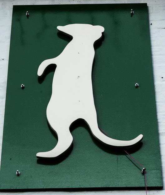 Meerkat logo on a green sign for The Royal Oak Pub.