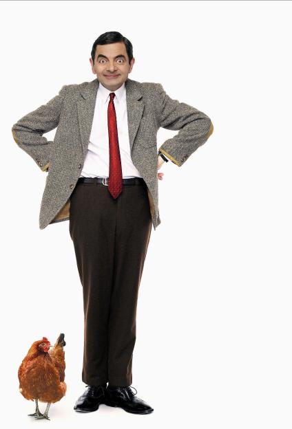 Mr. Bean smiling with a chicken by his feet, from Mr. Bean's Holiday.