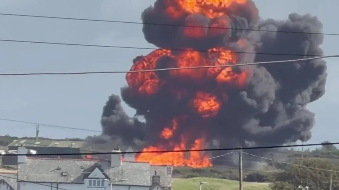 A massive fireball and thick black smoke rise into the sky after a Hawk T2 training aircraft crashes near the village of Rhosneigr.