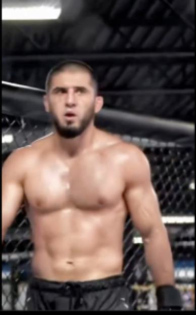 Islam Makhachev without a shirt, standing in an octagon.