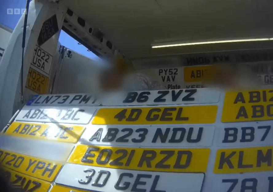 A pile of license plates for cars with different letters and numbers.