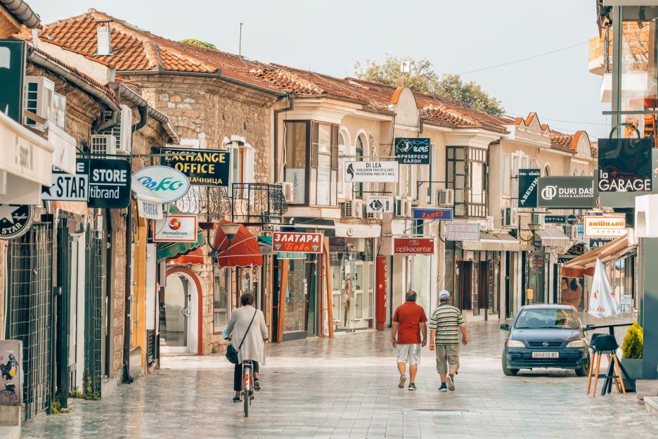 Central walking street in Ohrid, North Macedonia, with shops, cafes, and people.