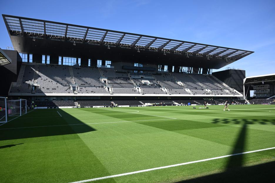 Fulham's new Riverside Stand and football pitch bathed in morning sunshine.