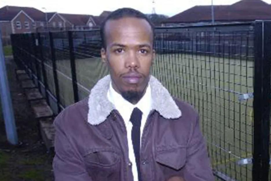 An image collage containing 1 images, Image 1 shows Essa Suleiman standing in front of a fenced sports court