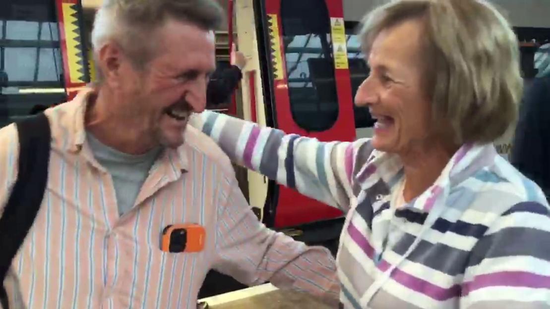 Michael Bardsley and his sister Gill Thompson embrace, smiling, at their first meeting after 73 years.