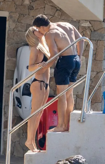 Ellie Goulding and boyfriend Beau Minniear kiss by the water at the Hotel du Cap-Eden-Roc in the South of France.