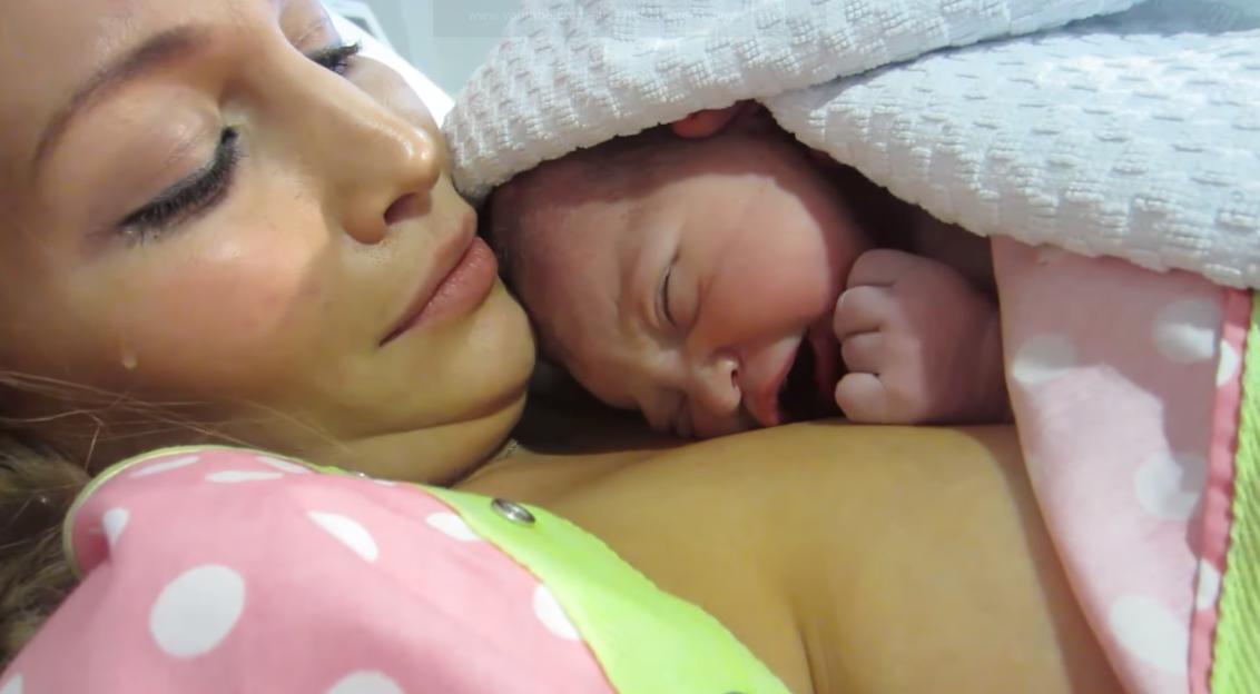 Mother Anna Saccone with tears in her eyes as she holds her newborn baby Jonathan Joly.