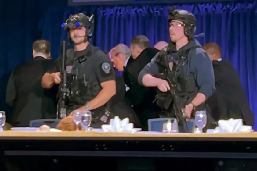 Security personnel, wearing helmets and tactical gear, standing guard during an event.