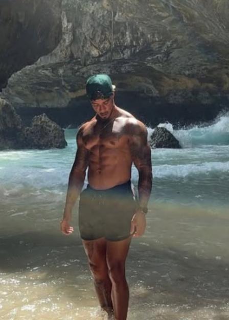 Virgil Sint Jago shirtless in the ocean.