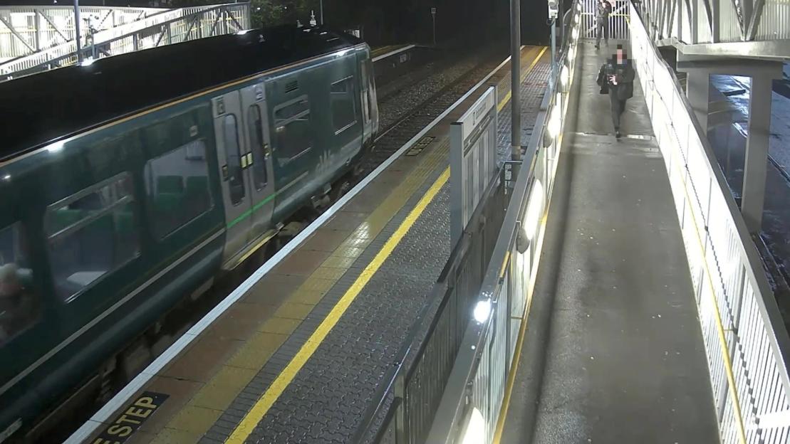 Video grab of police arresting a teen on a train platform.