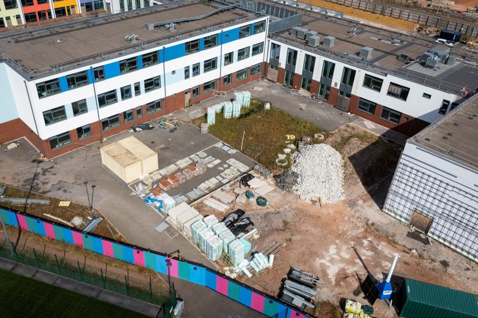 An aerial view of the Matford Brook Academy with materials in its courtyard.