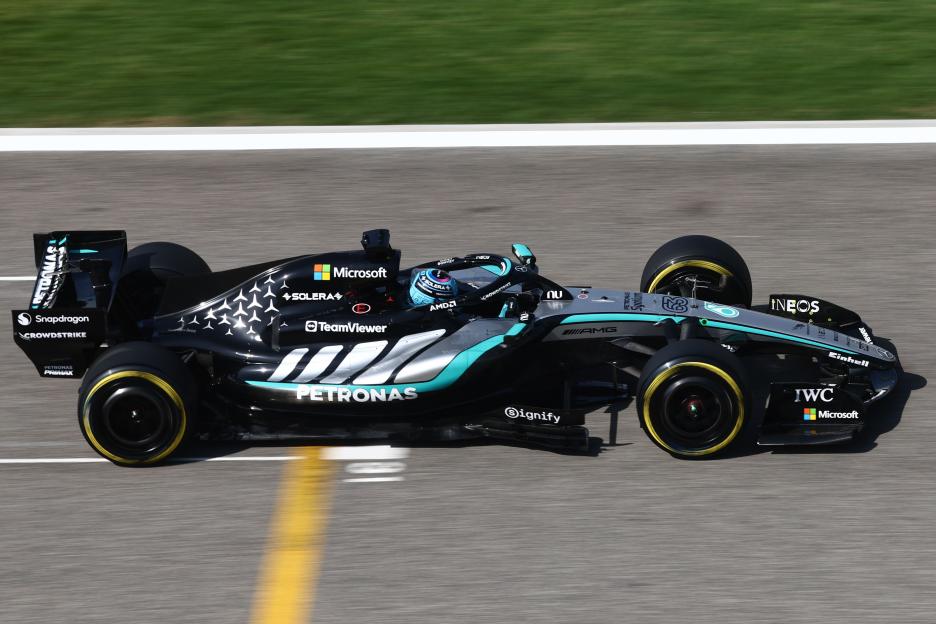George Russell driving a black and turquoise Mercedes Formula 1 car during pre-season testing.