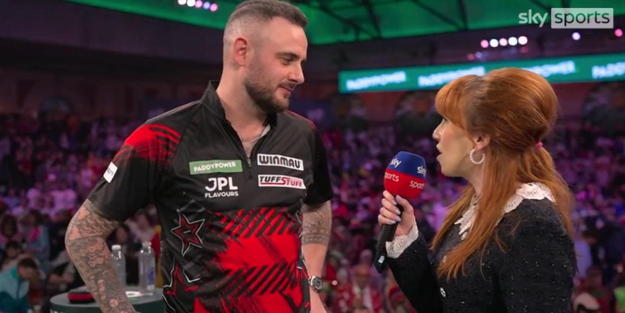 Sky Sports interviewer holding a microphone speaking to a male athlete.