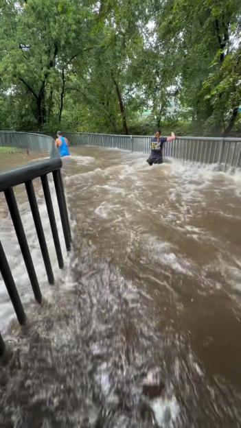 Half marathon runners forced to trudge through waist-high water as ‘dangerous’ race goes ahead despite severe flooding