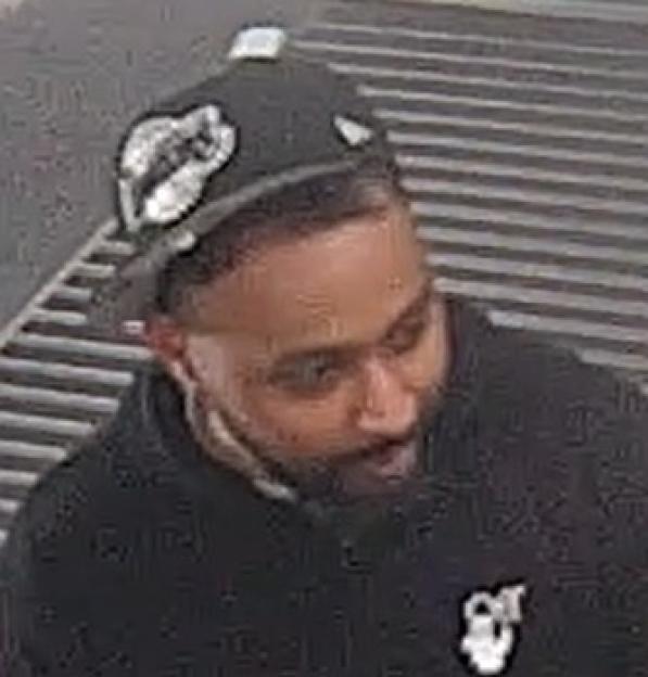 Image of a man in a black baseball cap and black hoodie.